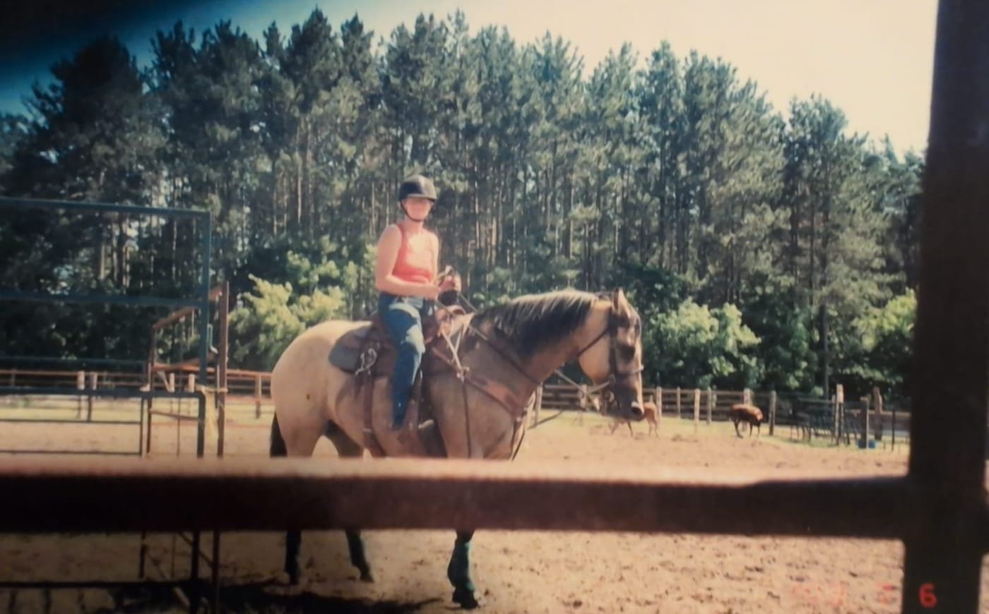 A young rider schooling Sierra in the outdoor arena